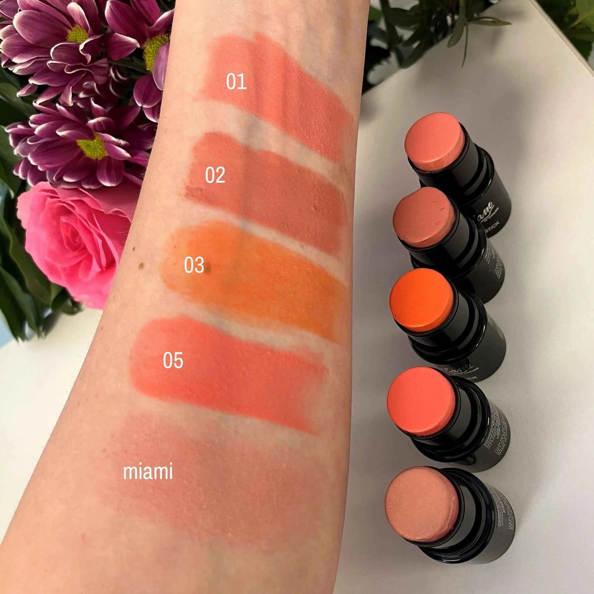Blush en Stick — rendu naturel des 5 teintes swatchées sur la peau : 01, 02, 03, 05 et Miami